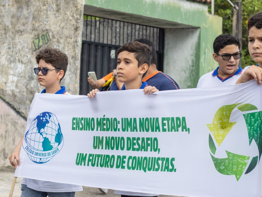 Alunos do Ensino Médio no desfile com a faixa “Ensino Médio: uma nova etapa, um novo desafio, um futuro de conquistas”